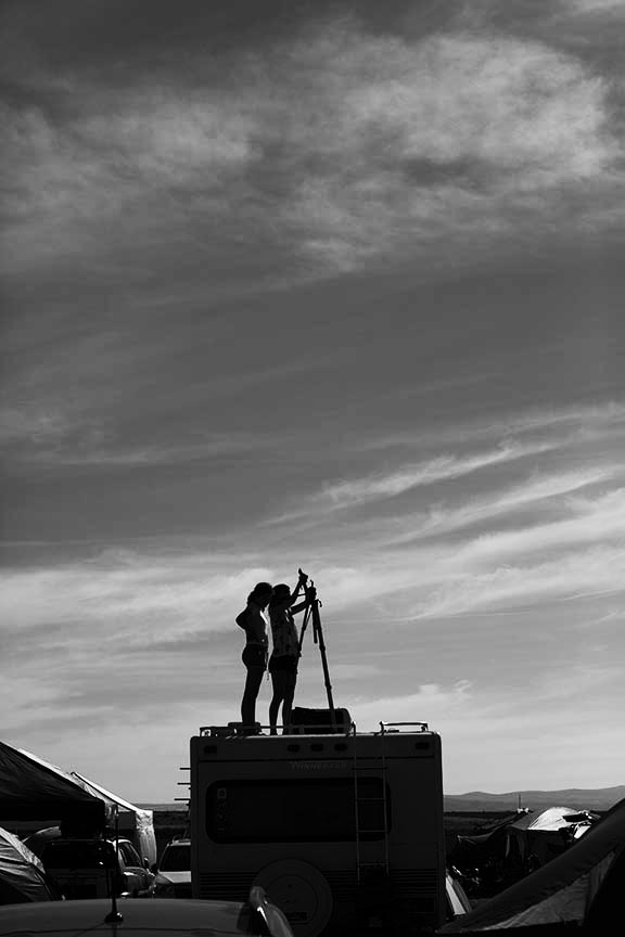 two women observing the sky before totality