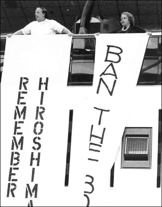 Elmer Maas and Norma holding banners