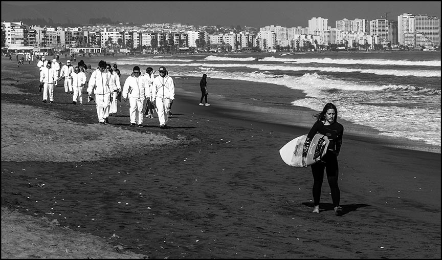 lifeguards trailing surfer on La Serena's beach